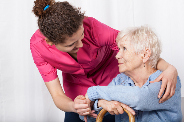 Woman supporting elderly woman