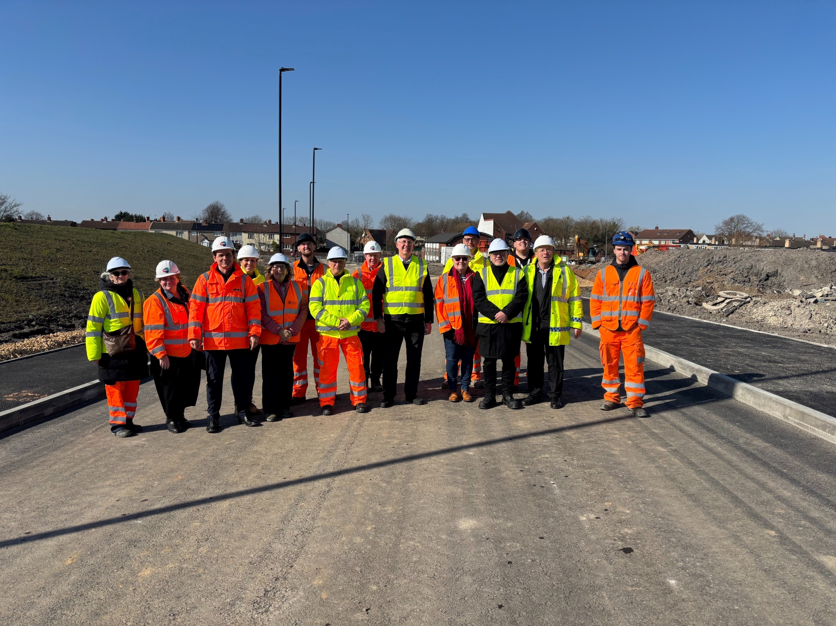 Delegates pose for a photo on the new link road