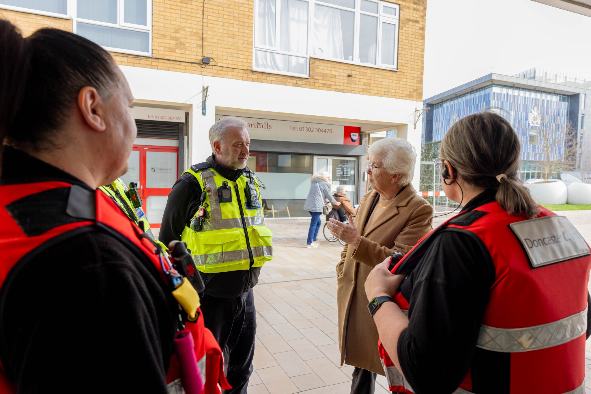 Mayor talking to engagement officers outside shops 
