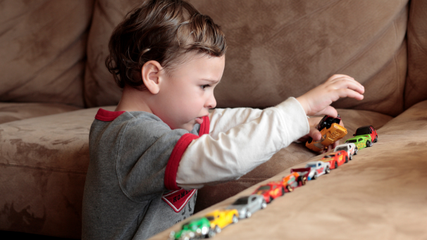 Child playing with toy cars